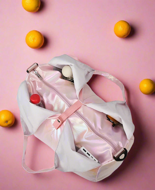 Pink storage bag with multiple pockets on a pink background with oranges
