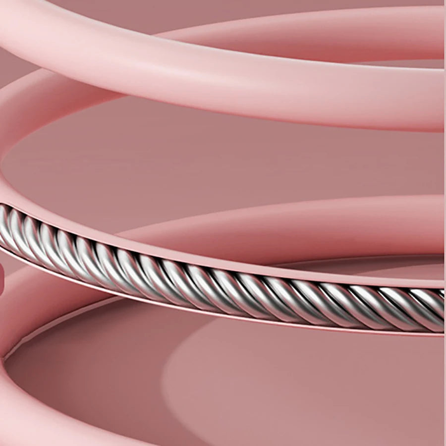 Close-up of pink cable with a metallic core on a pink background